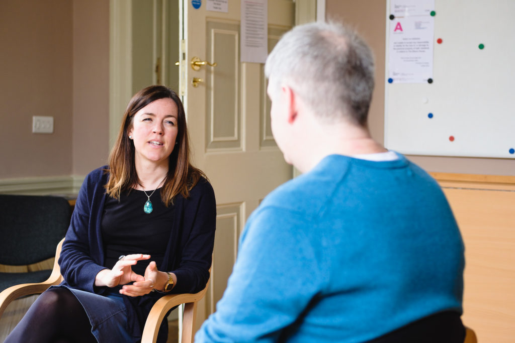 Corporate marketing photography - image from a series showing a relaxed conversation used in marketing material by charity Action on Addiction