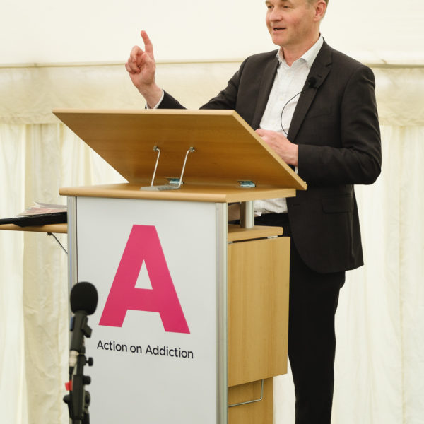 Corporate event photography with chief executive of charity Action on Addiction (Graham Beech) making a presentation at a conference