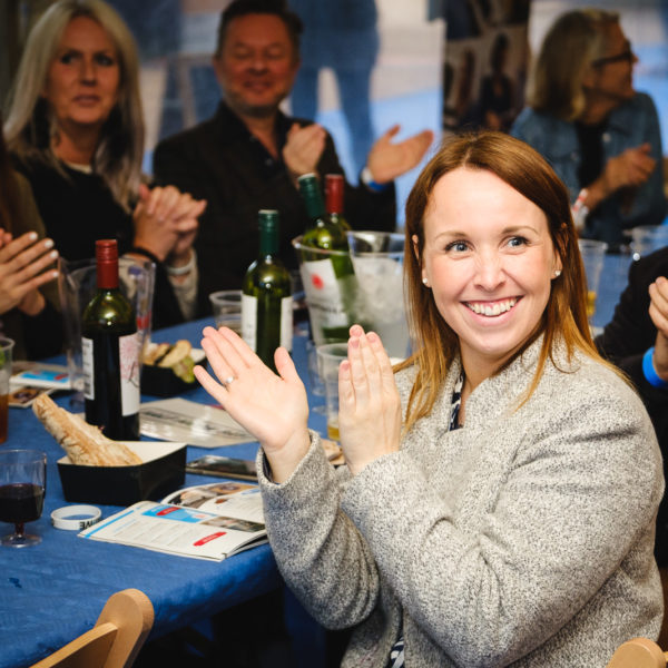 Corporate event photography at Bath Creative Awards with female guest enjoying prize giving ceremony