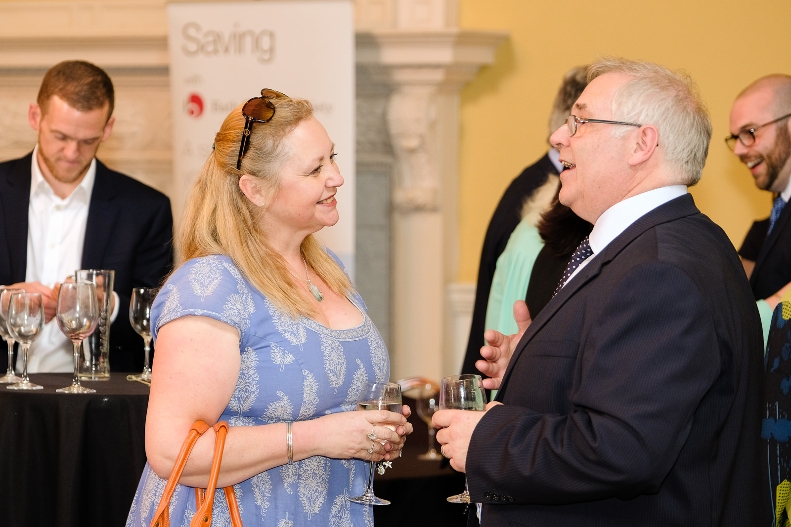 Corporate event photography with lady talking to chief exec at the Bath Assembly rooms