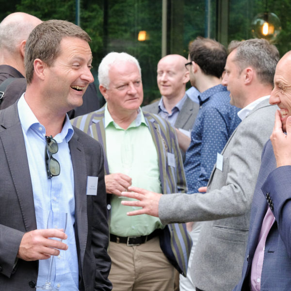 Corporate event photography - men chatting at corporate event at Holborn Museum in Bath