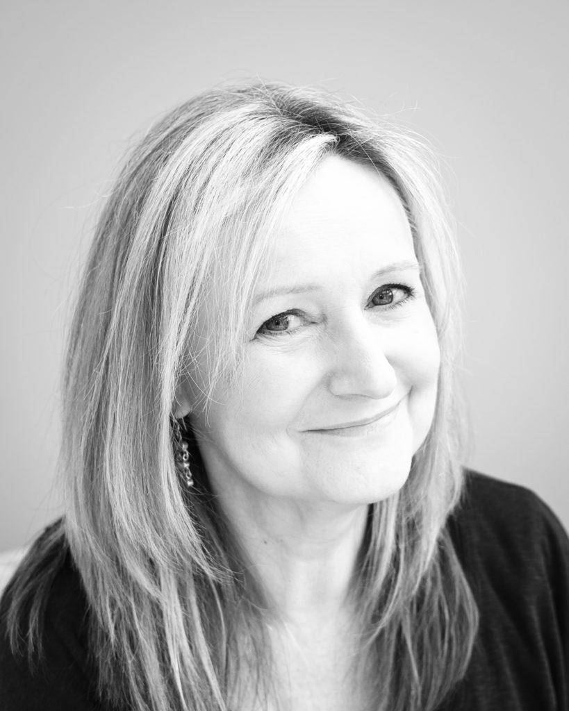 Relaxed black and white headshot of lady with long hair