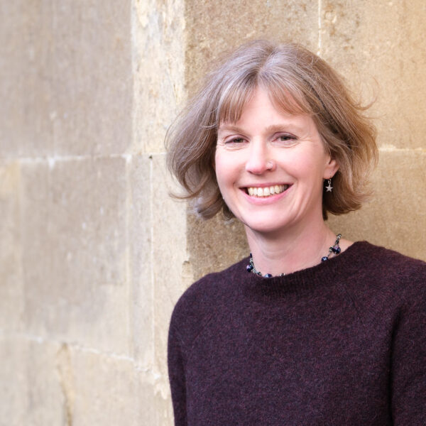 Headshot of Liz Jones with Cotswold stone backdrop