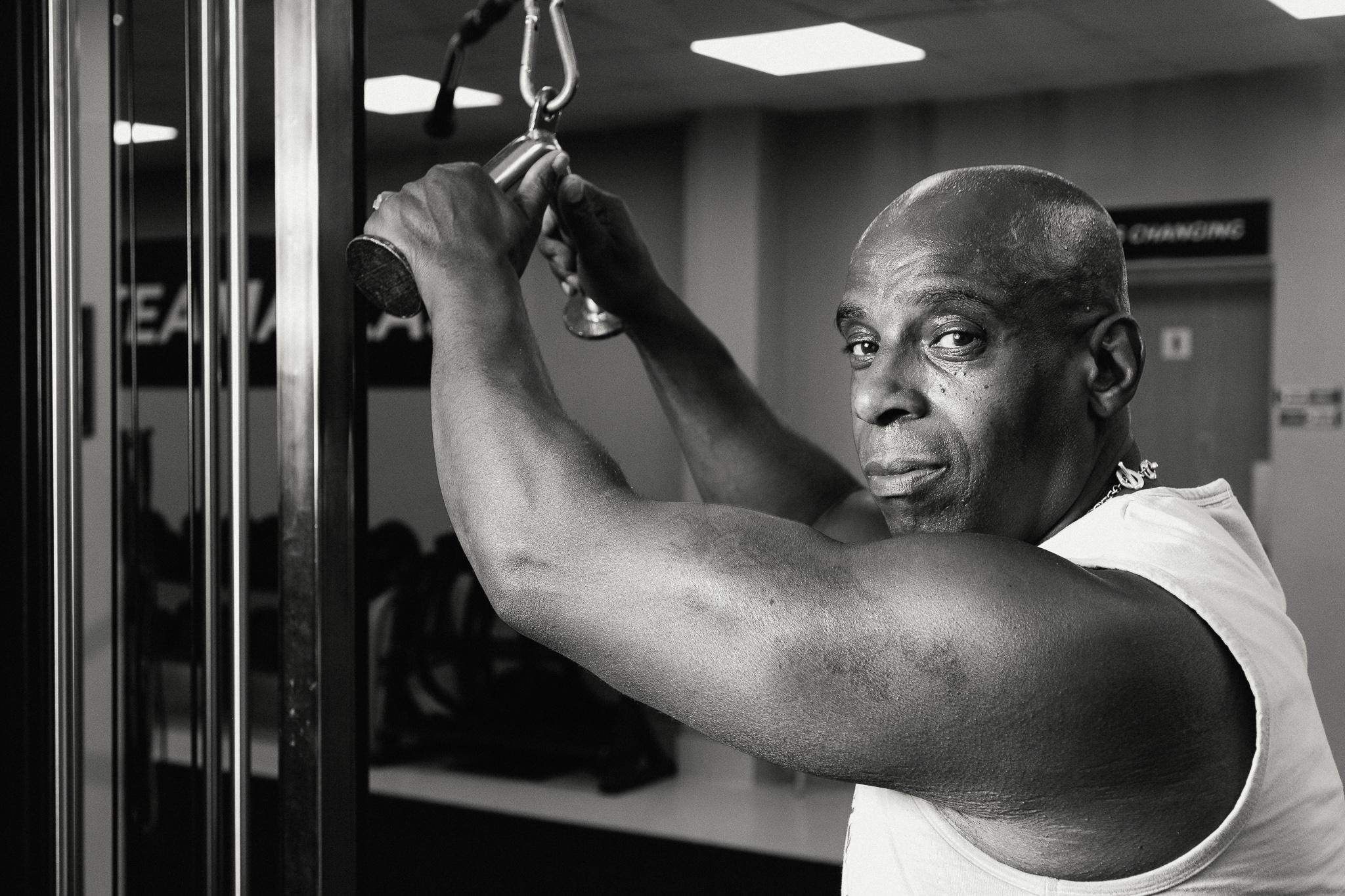 Business storytelling photography - male lifting weights in his local gym