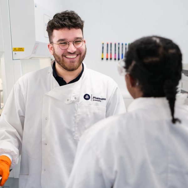 Young research chemists talking with each other in the laboratory