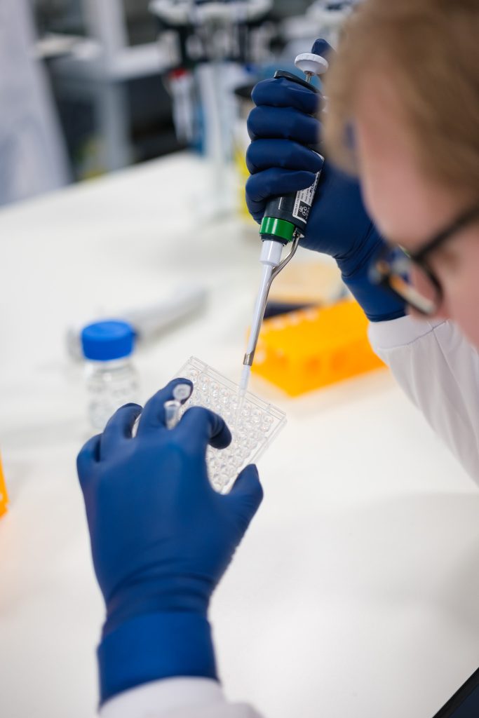 Chemist working with a micro pipette