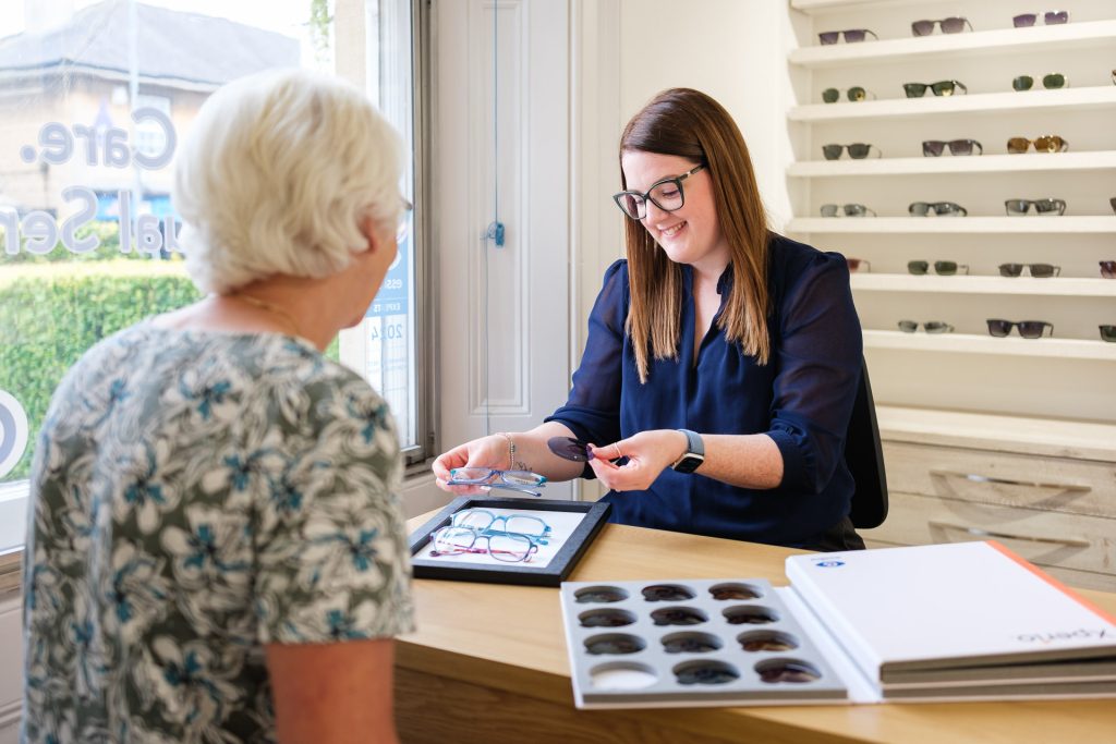 Female client discusses spectacle options with a dispensing optician