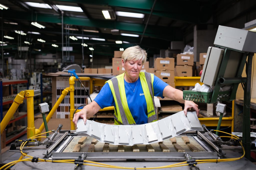 Manufacturing photography showing a female production operative on the factory floor