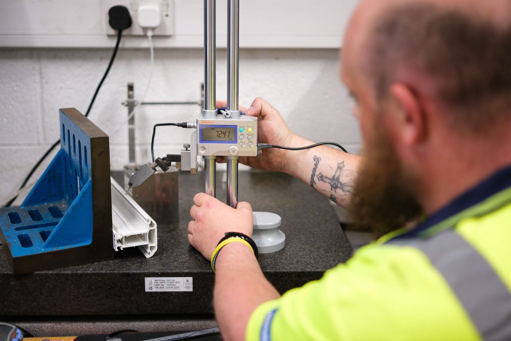 Manufacturing photography showing a quality assurance technician testing a product
