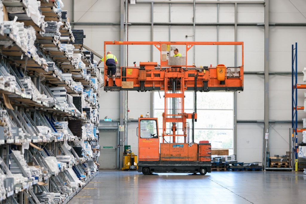 Manufacturing photography showing a high rack fork lift in a warehouse