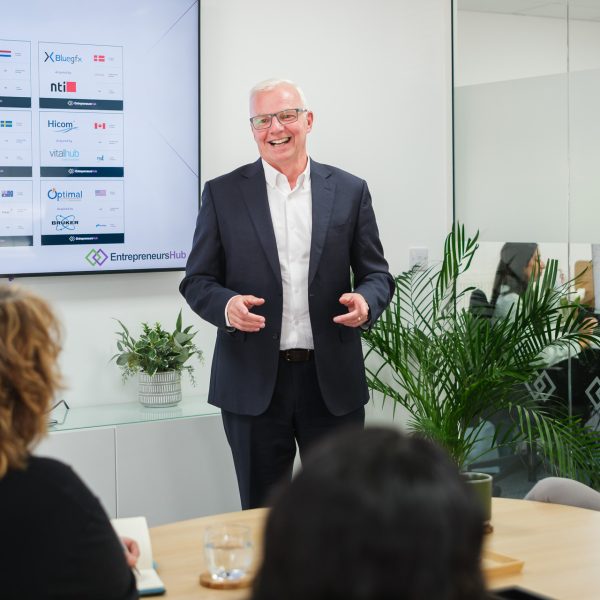 Business director presenting to the team in a relaxed meeting space