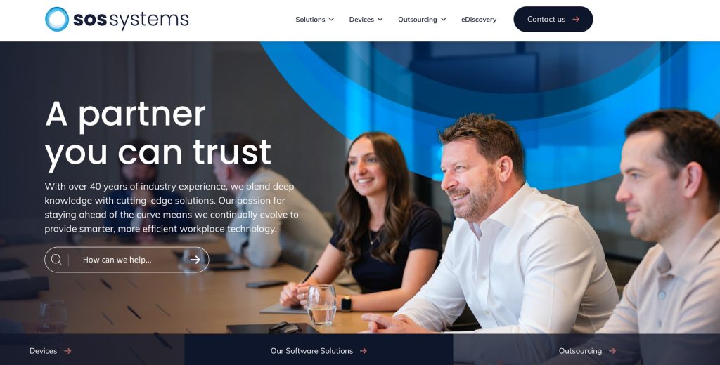 A home page banner photo created for SOS Systems showing the team interacting with each other.