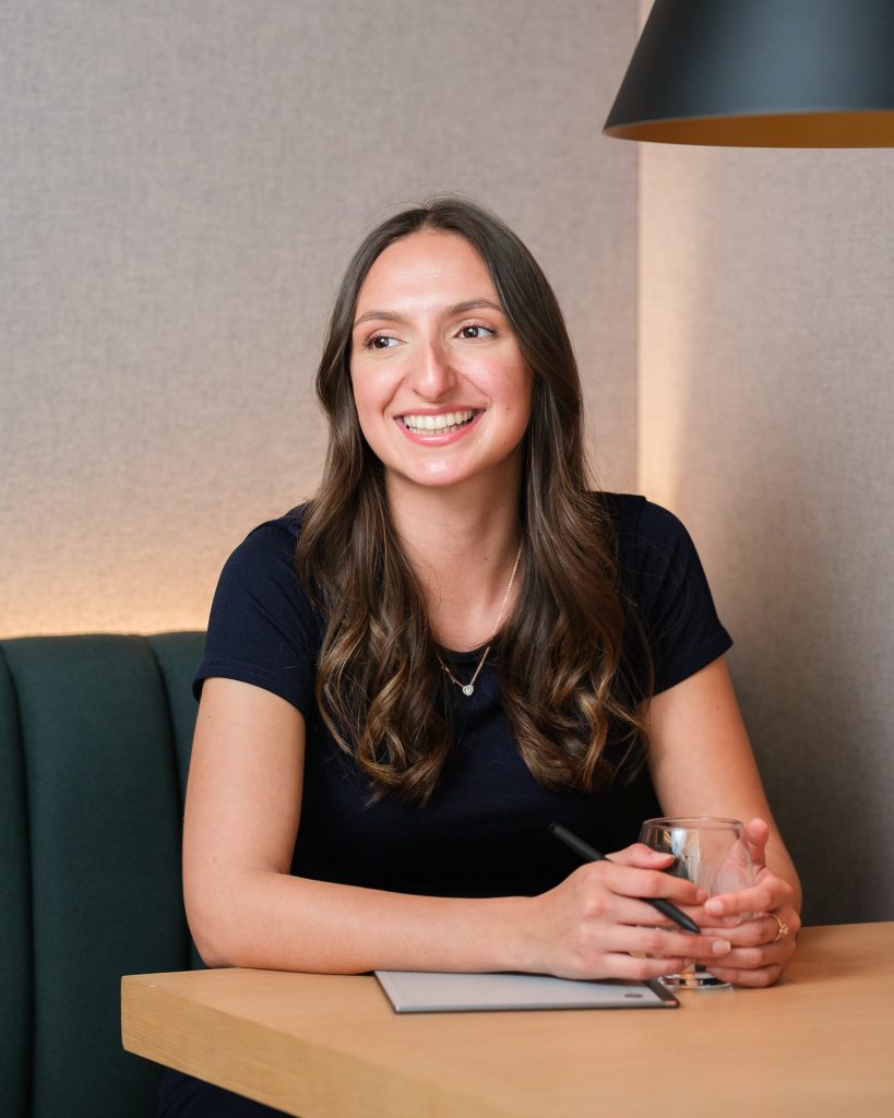 Business team member smiling in a modern tech workspace