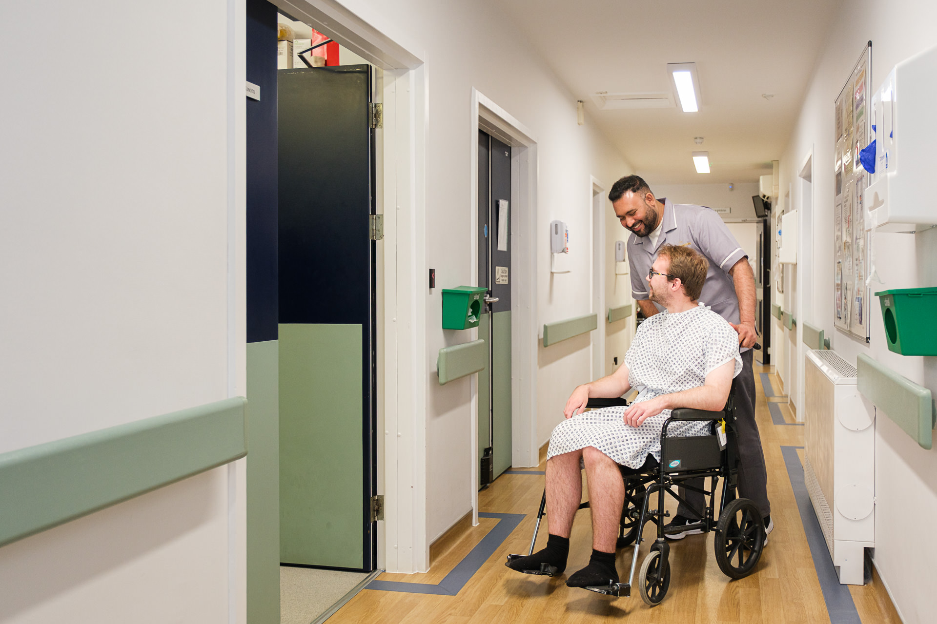 Patient being assisted through a hospital corridor at The New Foscote Hospital