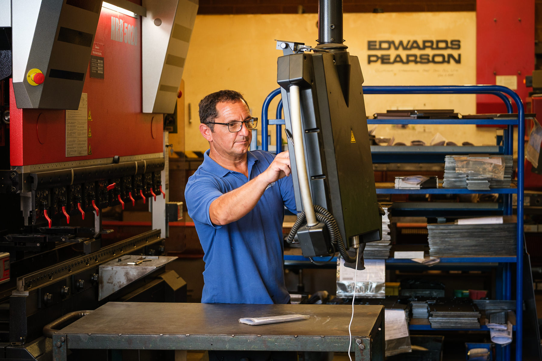 Engineer setting up a CNC press brake for precision metal fabrication