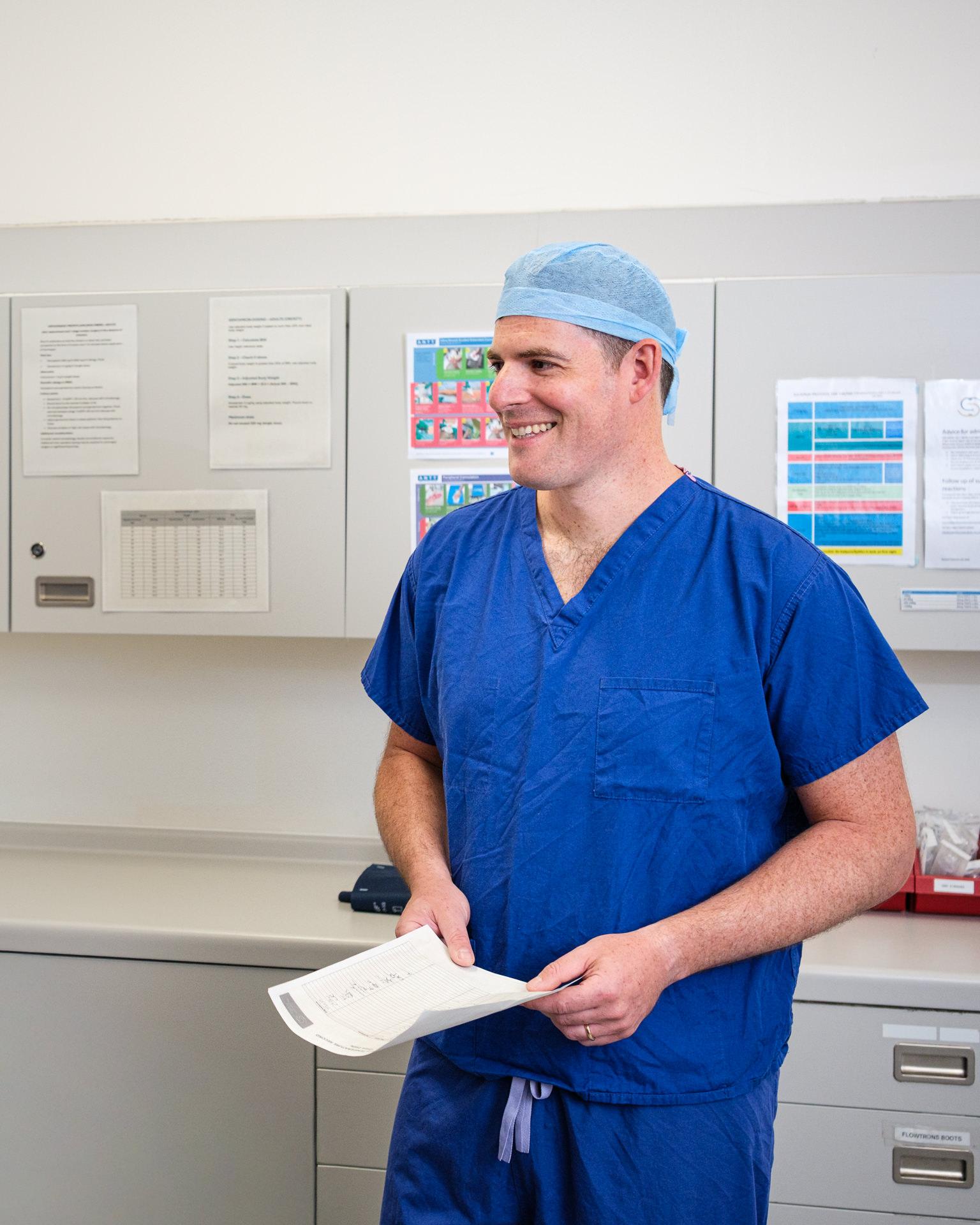 Consultant orthopaedic surgeon James Berwin smiling in surgical scrubs at Sulis Hospital in Bath.